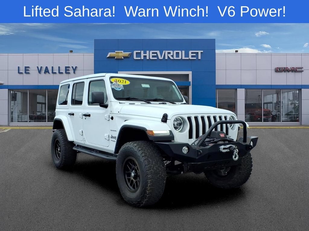 2021 Jeep Wrangler Unlimited Sahara in White — front three-quarter view